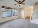 Bright living room with neutral carpet, large windows, and a ceiling fan at 2994 E Megan St, Gilbert, AZ 85295