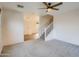Living room featuring neutral carpet, a ceiling fan, and staircase access at 2994 E Megan St, Gilbert, AZ 85295