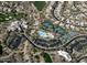 Aerial view of community center with pool, tennis courts, and golf course, nestled among desert homes at 32472 N 68Th Pl, Scottsdale, AZ 85266
