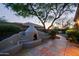 Stunning backyard features an outdoor fireplace, patio and manicured trees at 32472 N 68Th Pl, Scottsdale, AZ 85266