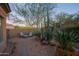 Landscaped backyard features a seating area, mature trees and rock ground cover at 32472 N 68Th Pl, Scottsdale, AZ 85266