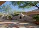 Inviting backyard with stucco fireplace, shade trees and paver patio at 32472 N 68Th Pl, Scottsdale, AZ 85266