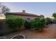 Desert backyard with gravel, mature landscaping, block wall and view of single story home at 32472 N 68Th Pl, Scottsdale, AZ 85266