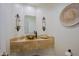 Stylish powder room showcasing a vessel sink, decorative sconces, and designer wall accents at 32472 N 68Th Pl, Scottsdale, AZ 85266