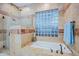 The bathroom features a walk-in shower, glass block window, and soaking tub at 32472 N 68Th Pl, Scottsdale, AZ 85266