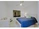 The bedroom features a ceiling fan, window, white furniture, and a blue comforter at 32472 N 68Th Pl, Scottsdale, AZ 85266