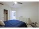 The bedroom features a ceiling fan, and white furniture and is brightly lit at 32472 N 68Th Pl, Scottsdale, AZ 85266