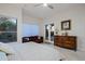 Bedroom suite with French doors, an area for seating, and tile flooring at 32472 N 68Th Pl, Scottsdale, AZ 85266