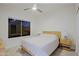 Bright bedroom features a ceiling fan, window, and a wood bed frame at 32472 N 68Th Pl, Scottsdale, AZ 85266