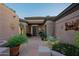 Cozy front patio with seating area, desert landscaping, and architectural details at 32472 N 68Th Pl, Scottsdale, AZ 85266
