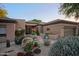 Welcoming front courtyard featuring desert plants, artistic details, and a covered entry at 32472 N 68Th Pl, Scottsdale, AZ 85266