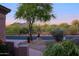 Well-maintained desert landscape in front of the house, with mature trees and rocks at 32472 N 68Th Pl, Scottsdale, AZ 85266
