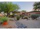 Beautiful single-story house with desert landscaping, rock features, and a well-maintained yard at 32472 N 68Th Pl, Scottsdale, AZ 85266