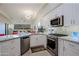 Bright kitchen featuring white cabinets, stainless steel appliances, and granite countertops at 32472 N 68Th Pl, Scottsdale, AZ 85266