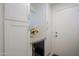 Mud room with white cabinets, granite countertop and access to the exterior at 32472 N 68Th Pl, Scottsdale, AZ 85266