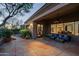 Covered patio featuring comfortable seating, tile flooring, and views of the meticulously landscaped backyard at 32472 N 68Th Pl, Scottsdale, AZ 85266