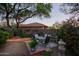 Relaxing backyard patio area with dining set and mature landscaping, creating a private outdoor retreat at 32472 N 68Th Pl, Scottsdale, AZ 85266