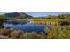 Calm pond reflecting mountain views, surrounded by lush greenery and parts of the golf course at 32472 N 68Th Pl, Scottsdale, AZ 85266