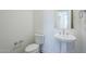 Clean bathroom featuring a pedestal sink, toilet, and minimalist design promotes a calming and refreshing atmosphere at 35524 N Tin Ct, San Tan Valley, AZ 85144
