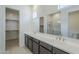 Bright bathroom features a double sink vanity and walk-in closet at 35524 N Tin Ct, San Tan Valley, AZ 85144