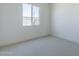 Bright bedroom with neutral carpet, natural light, and clean, white walls create a calming and inviting space at 35524 N Tin Ct, San Tan Valley, AZ 85144