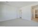 A bright bedroom offers a view to the ensuite bathroom with a glass-enclosed shower at 35524 N Tin Ct, San Tan Valley, AZ 85144