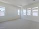 Bright bedroom with neutral carpet and an abundance of natural light from multiple windows at 35524 N Tin Ct, San Tan Valley, AZ 85144
