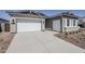 Wide driveway leads to a two-car garage, enhancing the home's curb appeal at 35524 N Tin Ct, San Tan Valley, AZ 85144