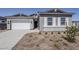 Charming home showcasing a brick and siding exterior with a well-manicured front yard at 35524 N Tin Ct, San Tan Valley, AZ 85144