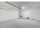 Spacious garage featuring a water heater, garage door opener, and ample space for storage at 35524 N Tin Ct, San Tan Valley, AZ 85144
