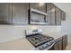 Modern kitchen with stainless steel appliances, subway tile backsplash, and custom cabinetry at 35524 N Tin Ct, San Tan Valley, AZ 85144