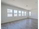 Minimalist living room with hardwood floors, large window, and an open airy feel at 35524 N Tin Ct, San Tan Valley, AZ 85144