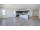 Open floor plan filled with natural light and wood flooring, connecting living spaces at 35524 N Tin Ct, San Tan Valley, AZ 85144