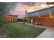 Lush backyard with a wooden structure, covered patio, and well-maintained lawn at 358 E Whitton Ave, Phoenix, AZ 85012