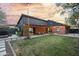 Expansive backyard with a covered patio, lush green lawn, and modern architectural design at 358 E Whitton Ave, Phoenix, AZ 85012