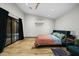 Bright bedroom with hardwood floors, ceiling fan, access to the outdoors, and a mini-split AC at 358 E Whitton Ave, Phoenix, AZ 85012