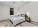 Clean, well-lit bedroom with light walls, wood floor, bedside lamps, and large window at 358 E Whitton Ave, Phoenix, AZ 85012