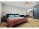 Bright bedroom featuring a queen bed, sofa, and wooden floors at 358 E Whitton Ave, Phoenix, AZ 85012