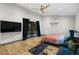Spacious bedroom with hardwood floors, ceiling fan, access to outdoor patio, and mini-split AC unit at 358 E Whitton Ave, Phoenix, AZ 85012