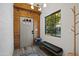 Modern entryway with wood accent walls, gray door, tiled floor, coat rack, and a view to the outside at 358 E Whitton Ave, Phoenix, AZ 85012