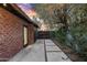 View of the home's brick exterior with patio walkway and gated entry to the property at 358 E Whitton Ave, Phoenix, AZ 85012