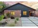 Charming single-story home with red brick and modern siding, a well-manicured yard, and a concrete driveway with grass accents at 358 E Whitton Ave, Phoenix, AZ 85012