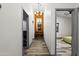 Hallway featuring hardwood floors, modern lighting, and an orange accent wall at the end of the hall at 358 E Whitton Ave, Phoenix, AZ 85012