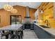 A modern kitchen with gray cabinets, wood floors, stainless steel appliances, and yellow tile backsplash at 358 E Whitton Ave, Phoenix, AZ 85012