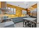 Modern kitchen with gray cabinets, concrete countertops, a yellow backsplash, and stainless steel appliances at 358 E Whitton Ave, Phoenix, AZ 85012