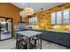 A modern kitchen with gray cabinets, wood floors, stainless steel appliances, and yellow tile backsplash at 358 E Whitton Ave, Phoenix, AZ 85012