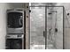 Modern laundry area with stackable washer and dryer and tiled shower at 358 E Whitton Ave, Phoenix, AZ 85012