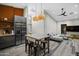 Open floor plan with a modern kitchen area flowing into a living room with a gray sectional and wood floors at 358 E Whitton Ave, Phoenix, AZ 85012