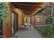 Charming covered patio with wood ceiling, ceiling fan, and outdoor dining table at 358 E Whitton Ave, Phoenix, AZ 85012