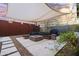 Modern outdoor patio featuring a built-in seating area, fire pit, and shade canopy at 358 E Whitton Ave, Phoenix, AZ 85012